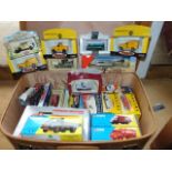 A vintage suitcase containing a quantity of boxed die cast model vehicles to include various