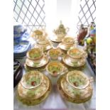 A collection of Victorian tea wares with painted rose decoration against a pale yellow and gilt