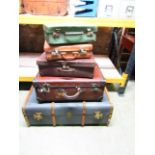 A vintage timber lathe and fibre cabin trunk together with four further items of luggage of