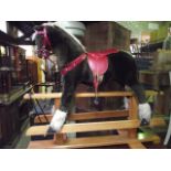 A contemporary child's toy rocking horse with plaque Pegasus rocking horse made in England