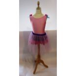 A child's contemporary ballet outfit in shades of purple and pink with net overlay skirt, the