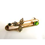 A Victorian style brooch, of scrolling form with shamrock motif, highlighted with seed pearls and