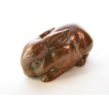 A coppered lustred model of a rabbit, the base stamped Stella