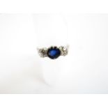 A sapphire and diamond ring, centred with a round mixed-cut untested sapphire weighing approximately