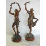 A pair of French bronze figures with patinated finish, one depicting a young male, the other
