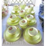 A quantity of yellow ground Foley china tea wares with printed floral sprays to the interiors of the