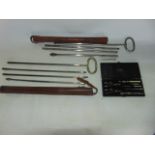Antique agricultural implements: Two stitched leather cased sets of hay rick heat rods, one