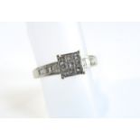 A diamond ring, centred with nine princess-cut diamonds weighing approximately 0.23cts in total,