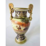 A Noritake two-handled vase, with continuous painted desert scene incorporating camels and riders,