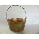 A single good quality antique brass jam pan with simple looping iron handle