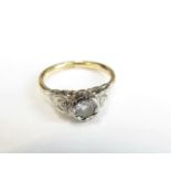 A diamond ring set with a round brilliant-cut diamond weighing approximately 0.20cts with stylised