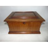 A mahogany veneered jewellery box with chamfered corners and hinged panelled top revealing a lined