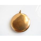 A 10ct gold locket, of plain circular form, 18.7gg