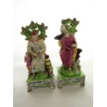 A pair of early 19th century Staffordshire models of Elijah and The Widow, both of usual form and