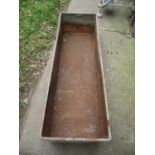 A vintage galvanised steel trough of rectangular form with folded lip and riveted seams, 5ft long