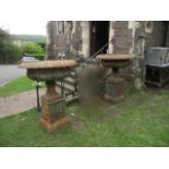 A pair of large weathered cast iron campana shaped garden urns, the shallow circular lobed bowls