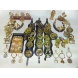 A collection of traditional 19th century horse brasses, some presented on martingales, others loose,