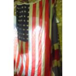 A large antique American flag together with a large antique Union Jack flag