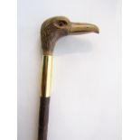 A slender bamboo walking cane terminating in an applied handle in the form of a ducks head set above