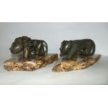 An unusual pair of eastern cast metal cats with applied detail, thought to be Indonesian, one in the