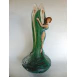 An unusual plasterwork vase in the Art Nouveau manner in the form of a female figure in flowing