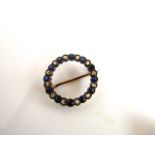 A Victorian style sapphire and diamond brooch, of circular form, set with alternating untested