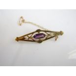 A gem-set brooch, of shaped kite form, centred with an untested amethyst, flanked to each side