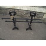 A pair of old English style cast iron andirons with open basket finials