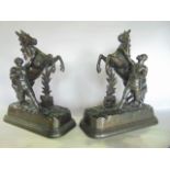 Sculpture: A good quality matched symmetrical pair of cast metal male figures each struggling to