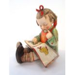 An unusual outsized Goebel figure of a little girl reading a book - Bookworm, with paper label to