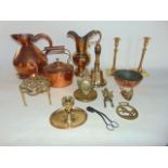 A collection of antique metal wares to include a copper kettle, measure, brass candlesticks,