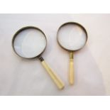 Two magnifying lenses with turned ivory handles, 10 cm diameter max