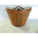 A good quality 19th century stitched tan leather hat box with rounded brass lock escutcheon and