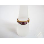 A ruby and diamond ring, centred with an oval mixed-cut untested ruby, flanked to each side with a