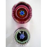 Two boxed Edinburgh Millefiori paperweights to include a faceted example with central foliate