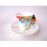 A Shelley Art Deco cup and saucer with painted stylised floral decoration in yellow, blue and orange