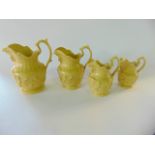 A set of four 19th century yellow ground graduated smear glazed jugs with relief moulded