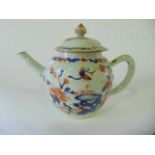 A 19th century oriental teapot of globular form with painted Imari type flowering and rock