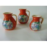 A set of three 19th century orange ground graduated jugs with printed and infilled chinoiserie