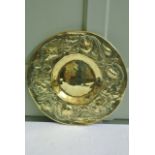 An Arts and Crafts polished brass charger with trailing floral band and punched detail 38cm diameter