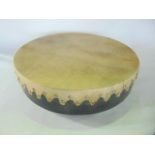 A simple hide drum or Bodhran of circular form with timber frame, stretchers and brass studs, 35cm