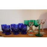 Six cobalt blue and clear cut drinking glasses with circular star cut feet together with four