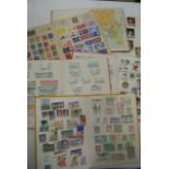 A collection of unsorted stamps worldwide together with some envelopes and a series of albums and