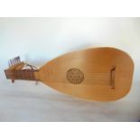 A 13 string timber lute with pierced sound hole and timber pegs