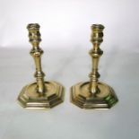 A pair of 18th century cast brass candlesticks on wide octagonal bases