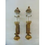 Railwayana; a pair of brass wall mounting candle sconces with cylindrical clear glass chimneys and