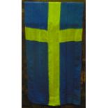 A large vintage Swedish flag suspended on a polish timber pole with brass pointed finial