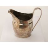 A Georgian silver cream jug, maker's mark RF, indecipherable date mark, of oval form, with bright-