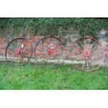 A pair of vintage implement wheels, with iron rims and spokes, 133cm in diameter approximately,