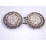 A sterling silver buckle, Birmingham, 1897, composed of two circular medallions each with